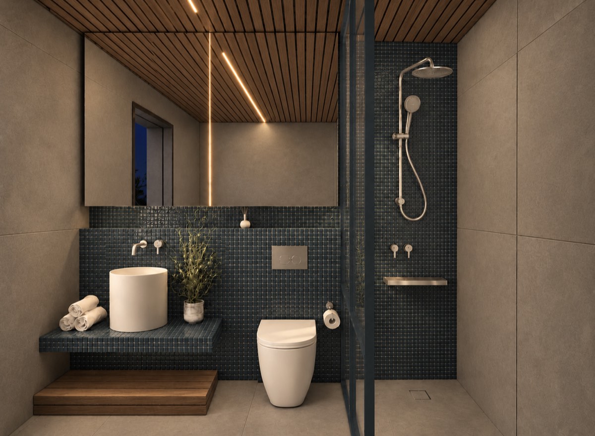 The bathroom of SOLUM Plus in Tide, with raw walnut joinery, after dark